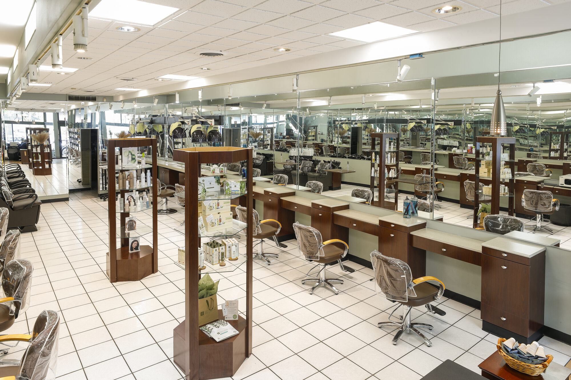 Interior of Pharaoh's Hairum on Park Avenue — rows of styling stations, mirrors, and organic product displays